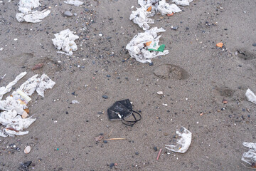 Beach full of garbage, wet wipes and waste that people throw in the toilet. Concept of ocean pollution and environmental destruction