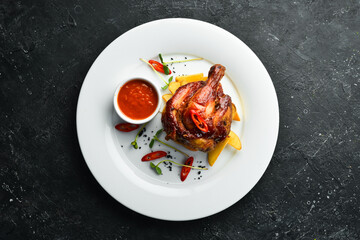 Chicken leg baked in honey sauce with potatoes. Restaurant dish. Menu. Top view.