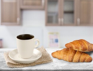 Espresso or black coffee in white cup with croissants