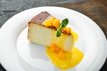 Dessert. Cheesecake with fruit topping on a plate. Top view.