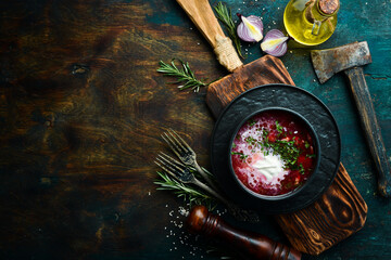 Beetroot soup. Ukrainian traditional cuisine - Borsch soup in a bowl. Rustic style. Top view.