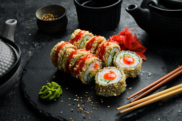 Grilled sushi rolls with salmon and eel on black background. Sushi menu. Japanese food.