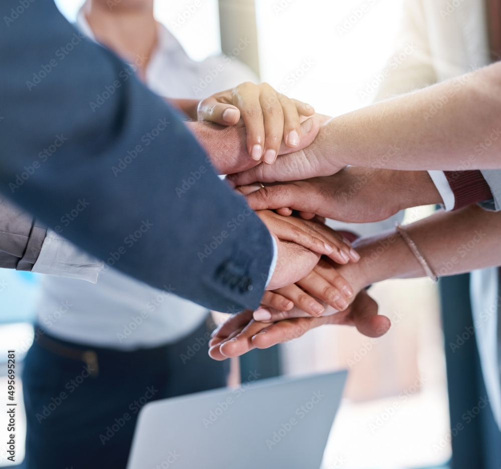 Poster Their hard work really adds up. Cropped shot of a group of unrecognizable businesspeople piling their hands on top of each other in the office.