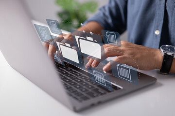 Paperless in the office. Worked on the laptop computer keyboard with electronic document icons displayed on the virtual screen.