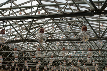 Glass roof and pendant lamps in form of large light bulbs.