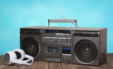Retro portable cassette tape recorder on wooden table  Vintage old style boombox.
