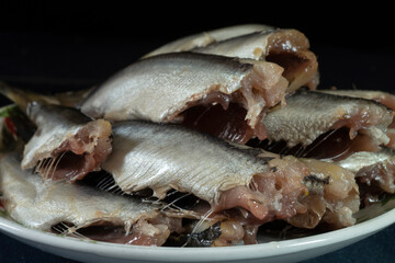 Salted fish in a white plate on the table