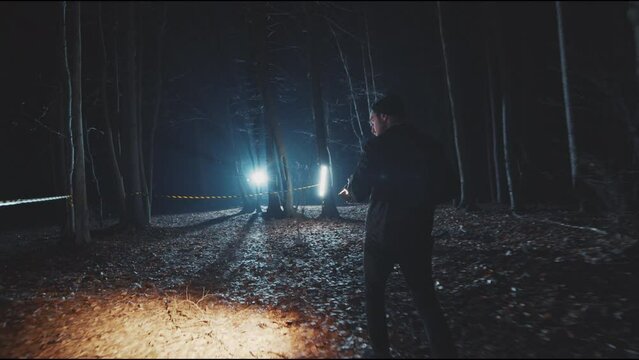 Security detectives men searching in woods at night with flashlight. Forest, equipment, searchlight, fog, criminal. Close up