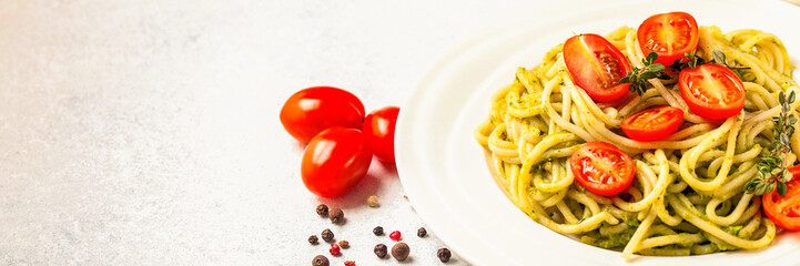 Paste with tomatoes and spinach sauce in a plate on a table. Selective focus. Copy space