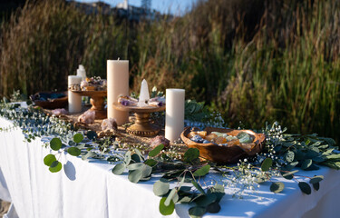 Beautifully decorated ceremonial table with mineral stones, smudging sticks, and candles