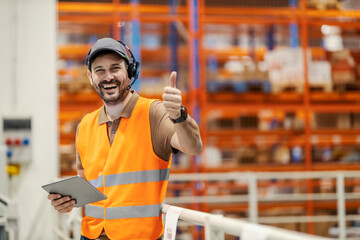 A delivery center manager showing thumbs up and smiling at the camera.