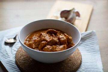 Chicken tikka masala dish bowl on a wooden table