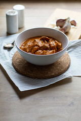 Chicken tikka masala dish bowl on a wooden table
