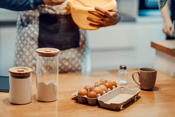 Close up of ingredients for a cake of cookies with a man baking.