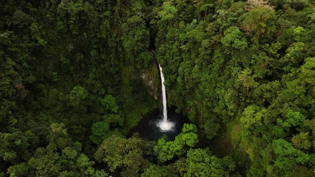 Panning wide aerial of fortuna waterfall and it's jungle, Costa Rica
