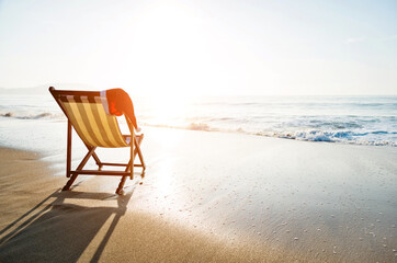 Close-up santa hat on beach chair.
