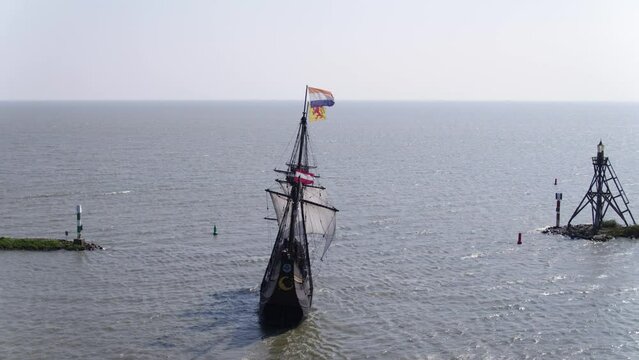 Historical Dutch VOC ship replica departs Hoorn harbour; aerial view