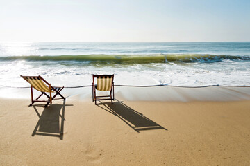 Two chairs on the beach.