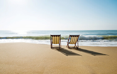 Two chairs on the beach.
