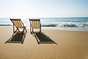 Two chairs on the beach.