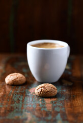 Amaretti (Italian biscuits) on rustic wooden background. Close up. Copy space.