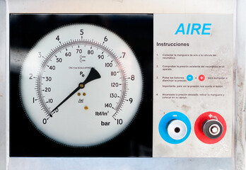 Naklejka premium Air compressor for vehicle tires at a gas station.