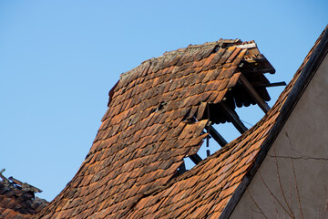 Damaged roof with old roof tiles on a old building