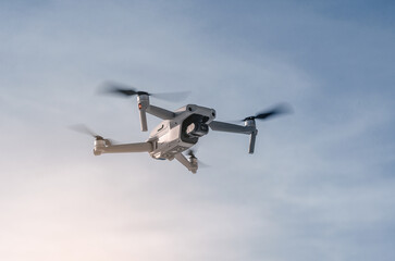 Drone flying in the air. Close. Blue sky background. New technologies.