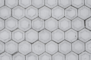 Wall with concrete honeycombs. Concrete gray hexagonal tiles, honeycomb tiles texture background.