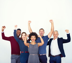 Obraz premium We did it. Studio portrait of a group of businesspeople raising their hands in celebration.