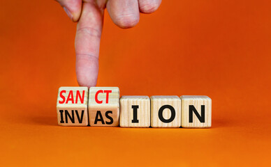 Sanction against invasion symbol. Businessman turns cubes and changes the concept word Invasion to...