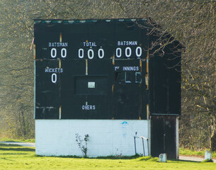 A cricket scoreboard is ready for the start of a new match and a new season with the hope of a warm summer of sport when it displays the feats of each team and their batsmen and bowlers
