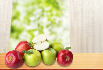 Green Apple fruit in wooden basket on natural garden background.