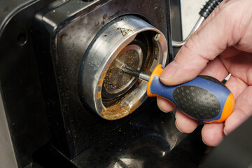 Man fixes old coffee machine.