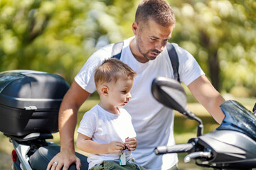 A father and son preparing for motorcycle ride.