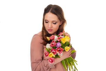 young girl with a bouquet of tulips on a white isolated background - 495710284