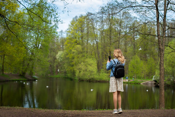 Fototapeta na wymiar young girl walking in spring park