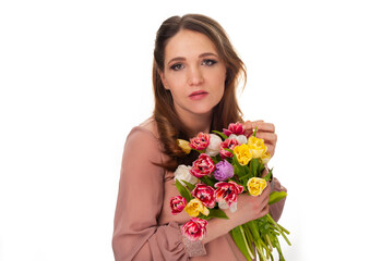 young girl with a bouquet of tulips on a white isolated background - 495710286