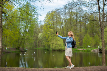 Fototapeta na wymiar young girl walking in spring park