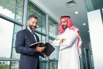 Arabian Businessman with a foreign businessman discussing work in a modern office 