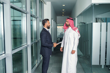 Arabian Businessman with a foreign businessman discussing work in a modern office 