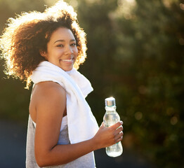 Stay hydrated. Stay healthy. Portrait of an attractive young woman getting a drink during her workout.