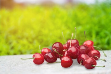 Fresh ripe cherries on a wooden table on natural background