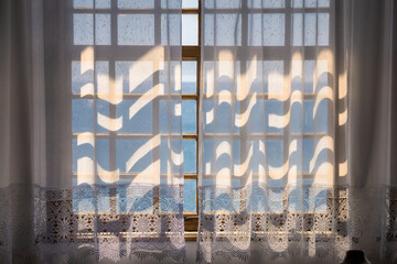 Glass windows with curtains under sunlight