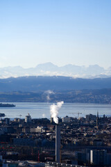 Aerial view over City of Zürich with Lake Zürich and Swiss Alps in the background on a blue and cloudy spring morning. Photo taken March 14th, 2022, Zurich, Switzerland.