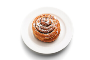 Cinnamon buns or cinnabon rolls, a homemade recipe for sweet traditional Dessert with white vanilla powder on red and white background.