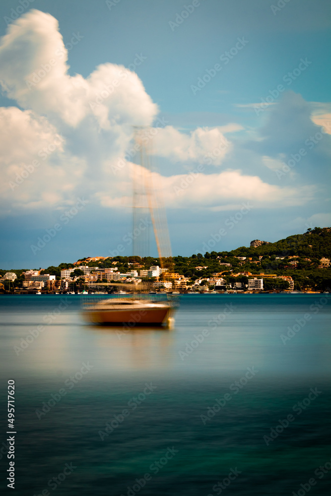 Wall mural Vertical photo of a lake, a boat and buildings on a forest hill in Geneva City in Switzerland