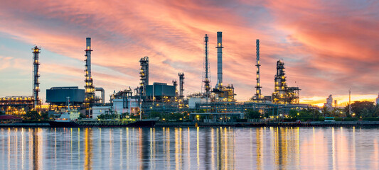 Oil and gas refinery plant area at sunrise	near sea port or river