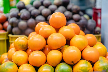 typical colombian fruits stacked in market place (lulo)
