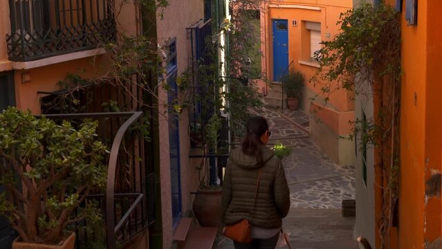 Woman tourist walking in Collioure traditional village with colorful houses on the south of France